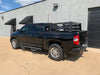 Rear drivers side view of black Toyota Tundra with Overland Bed Rack - Cali Raised LED