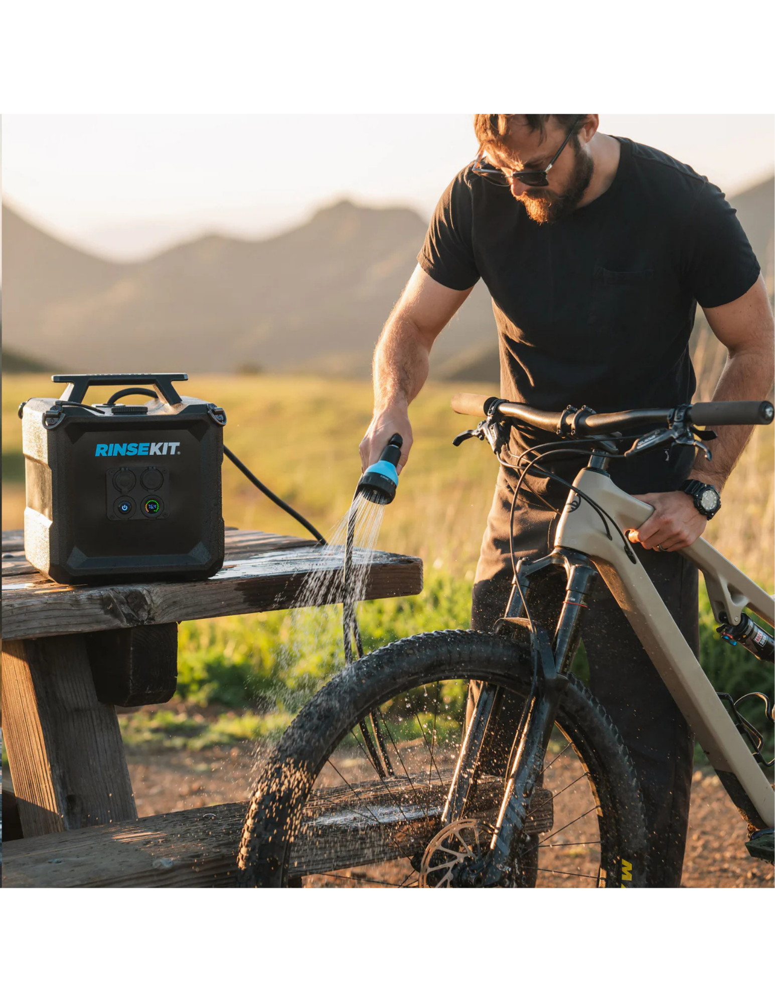 RinseKit Cube portable shower washing mountain bike after outdoor ride