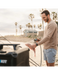 RinseKit Cube portable shower rinsing fish at beach after fishing