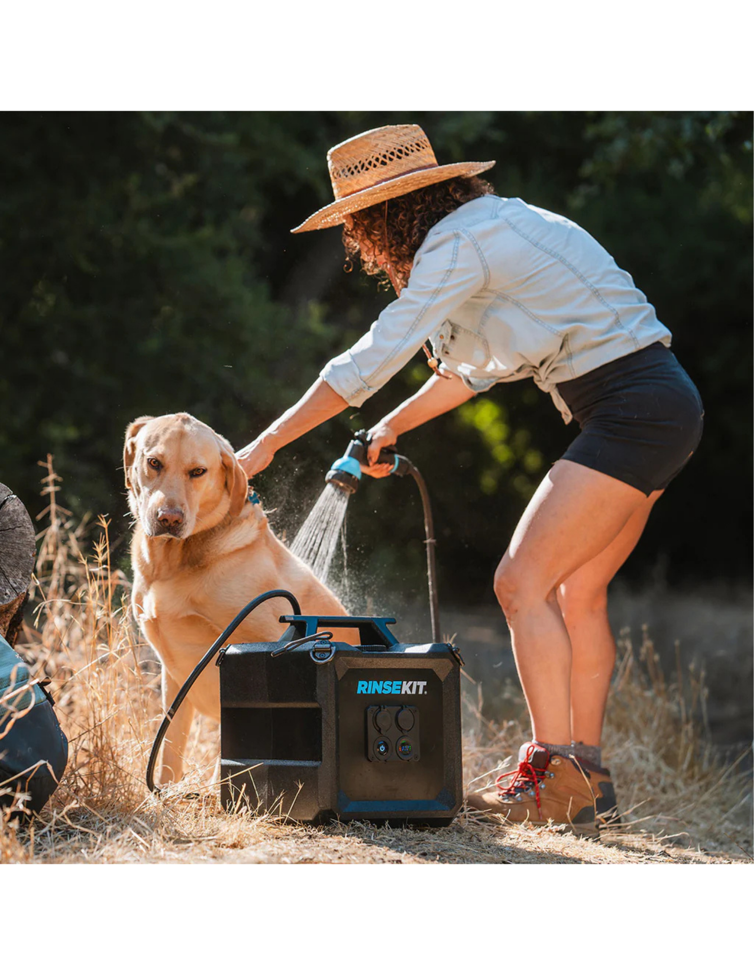 RinseKit Cube portable shower washing dog during outdoor adventure
