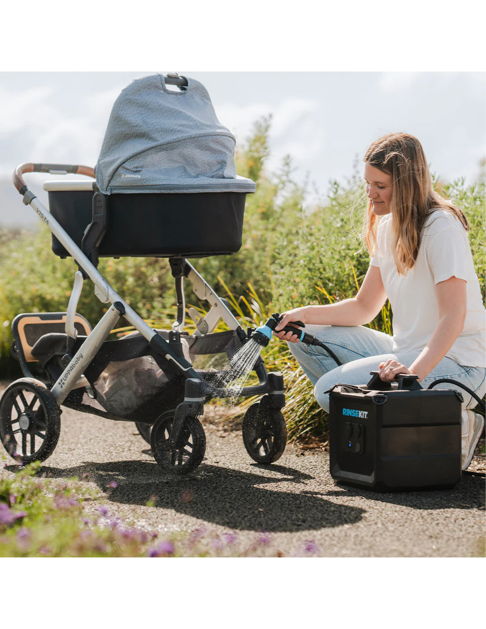 RinseKit Cube portable shower rinsing stroller wheels after outdoor walk
