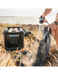 RinseKit Cube portable shower washing sandy swim fins near the beach