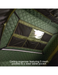 Ceiling organizer with mesh pockets and a clear tablet pocket on a green and black background