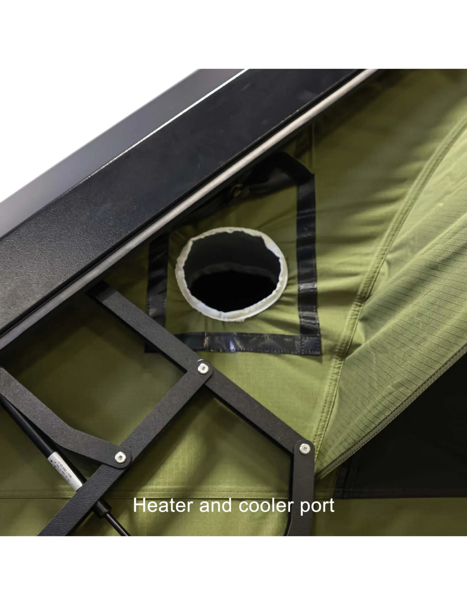Close-up of a green tent with a heater and cooler port feature.