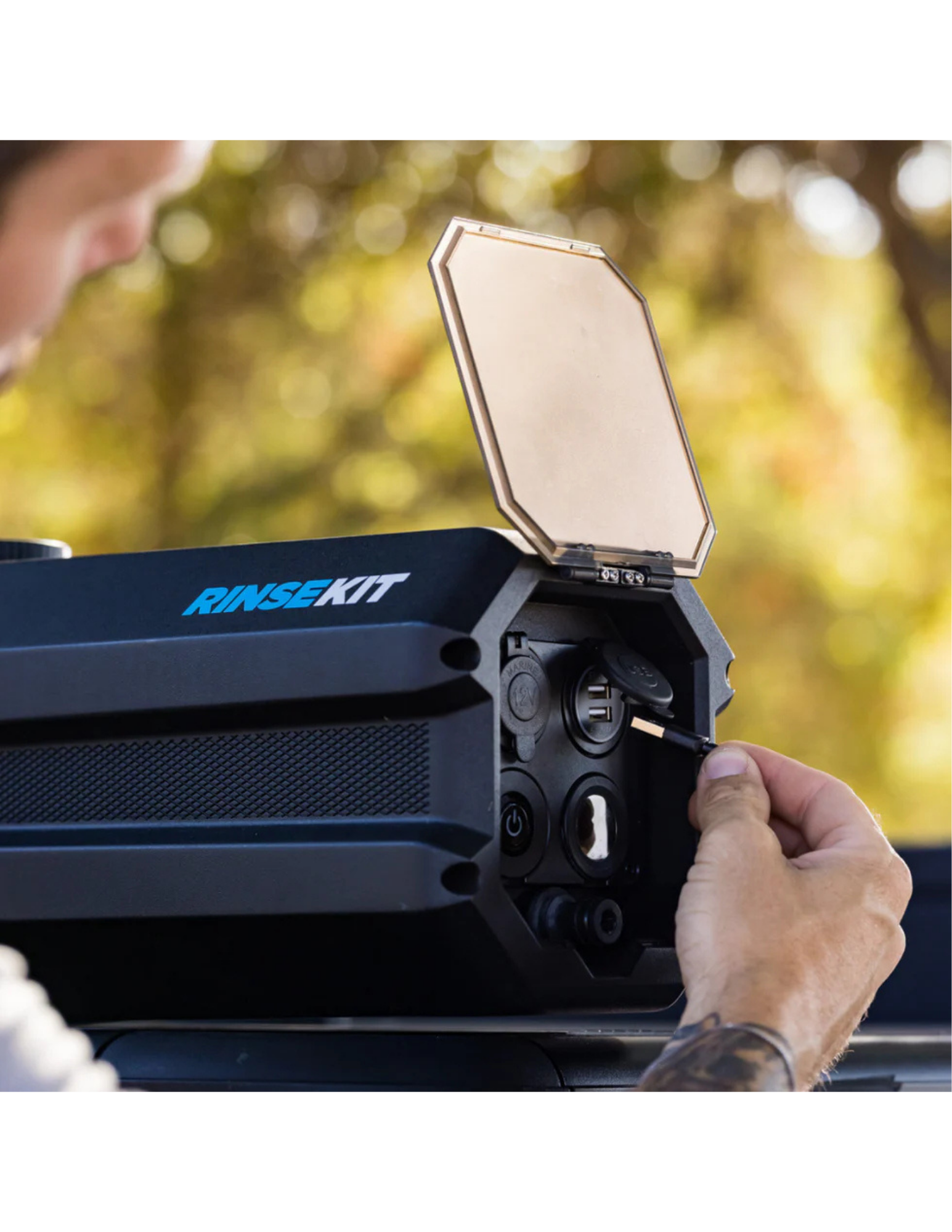 Close-up of RinseKit rack shower charging port and control panel on vehicle roof rack