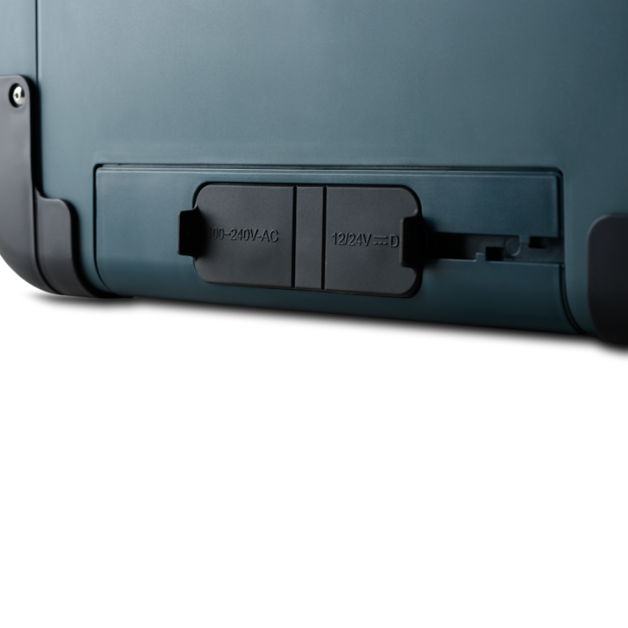 Green suitcase with power adapter slot on a white background