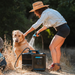 4 Gallon RinseKit Cube Portable Shower spraying dog