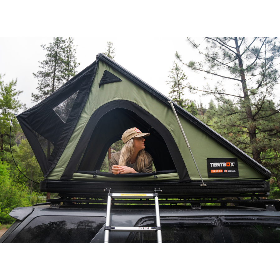 TentBox Cargo 2.0 Rooftop Tent side view with person laying in tent