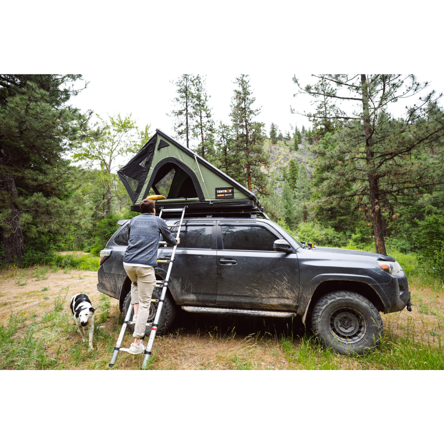 TentBox Cargo 2.0 Rooftop Tent with person climbing up ladder