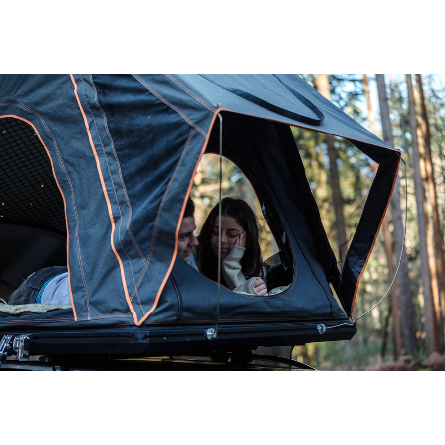 TentBox Cargo 1.0 Rooftop Tent close up view with two people in tent