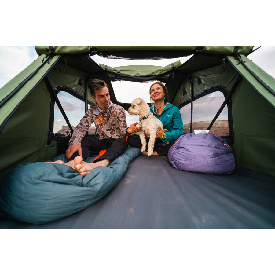 TentBox Lite 2.0 Rooftop Tent interior view with two people and dog