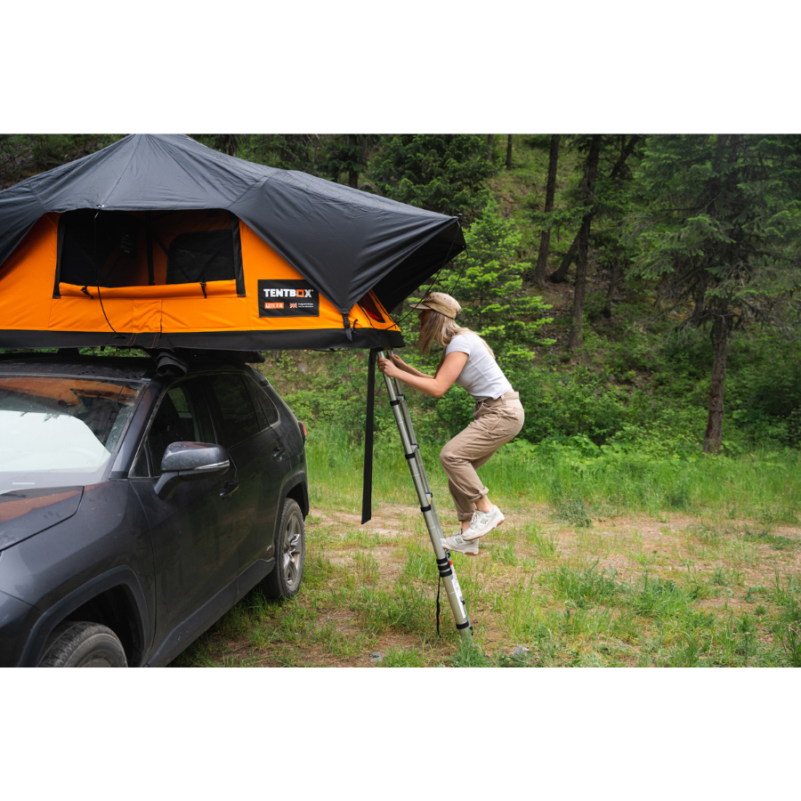 TentBox Lite 2.0 Rooftop Tent with person climbing ladder 